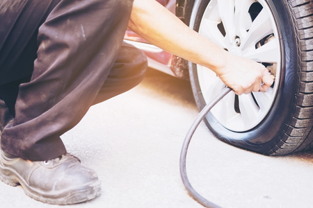 Technician is repairing car flat tireの写真素材