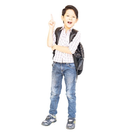 Seven year old Asian boy with a bag is ready to go to school isolated over whiteの写真素材