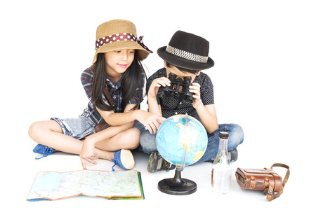 Asian boy and girl travelers are studying world map prepare to go, isolated over white backgroundの写真素材