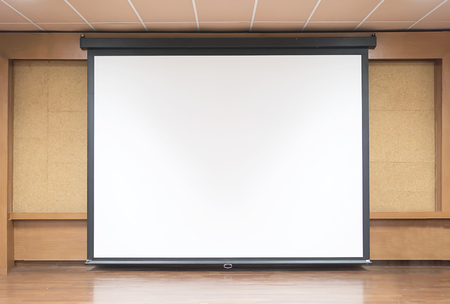 Front view of lecture room with empty white projector screenの写真素材