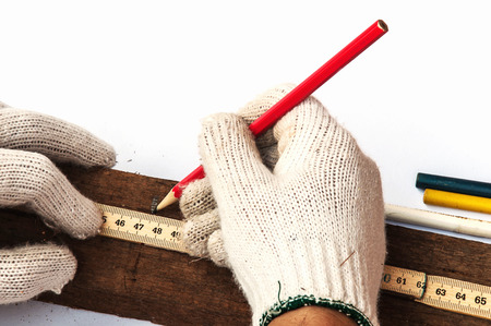 Male hands with ruler and pencil closeupの写真素材