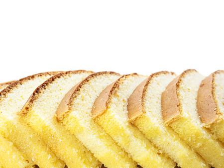 Row of inclined sliced butter cakes isolated over whiteの写真素材