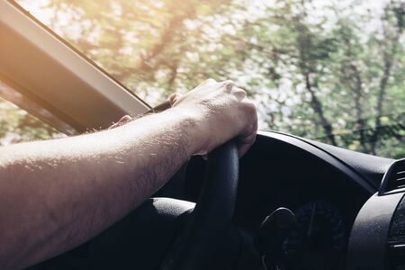 Man driving car using one hand