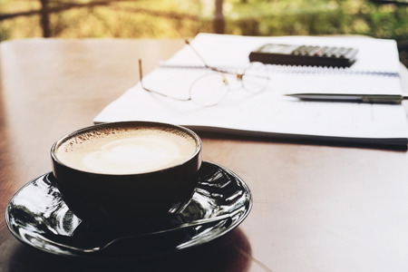 Office working item with coffee cup over wooden top tableの写真素材
