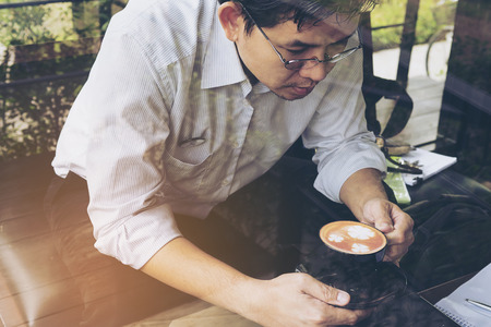 Businessman is working with his computer in coffee shopの写真素材