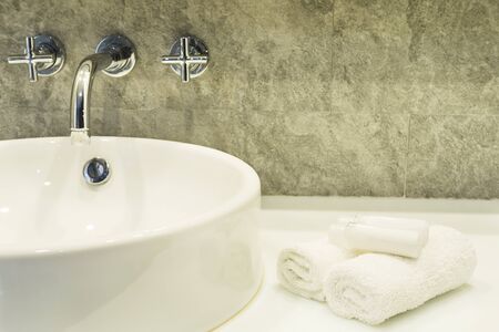 Bath room sink with white cleaning set in a hotel
