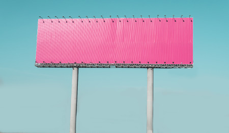 Empty pink highway billboard over blue sky background, your text hereの写真素材