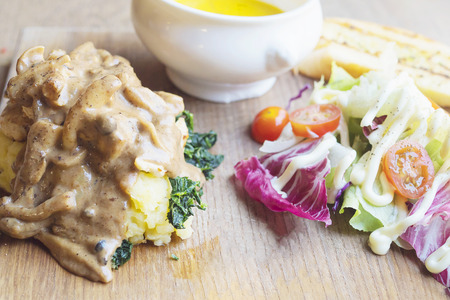 Roasted chicken served with salad and garlic breadの写真素材