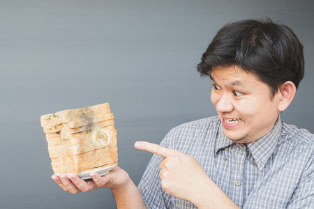 Man showing old fungi decay breadの写真素材