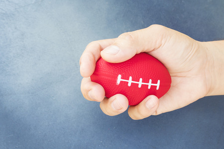 Soft rugby ball in hand for hand and finger exerciserの写真素材