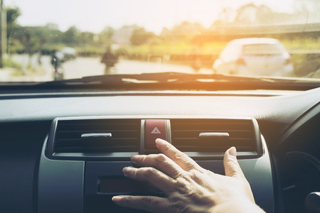 Man pushing emergency light button while driving carの写真素材