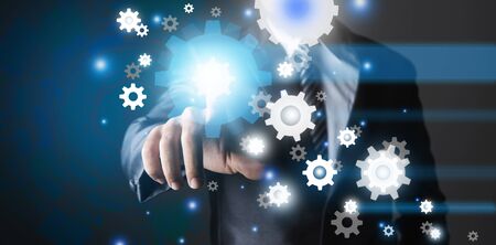 Business man pointing out to mechanical gear iconsの写真素材