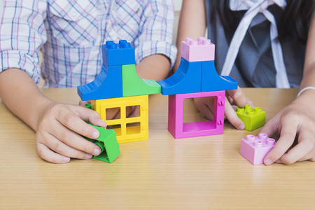 Kids playing pieces plastic creative construction blocksの写真素材