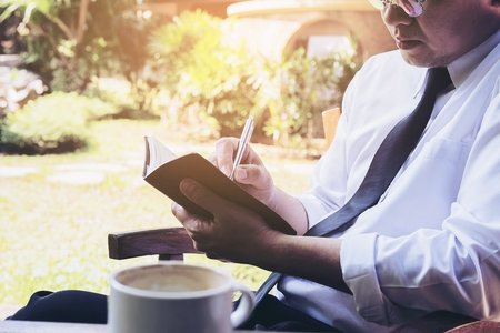 Business man working in coffee shopの写真素材
