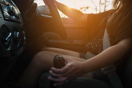Lady driving car holding automatic gear shift transmission controlの写真素材