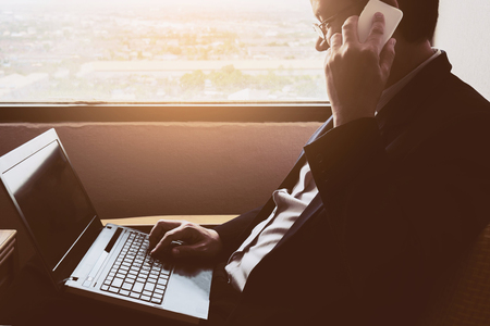 Business man working in hotel roomの写真素材