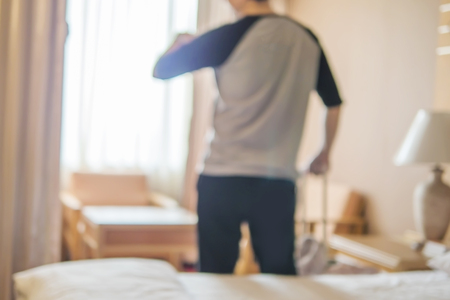 Blurred photo of travel man in hotel roomの写真素材
