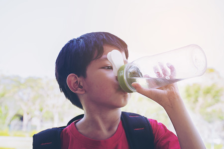 Boy drinking waterの写真素材