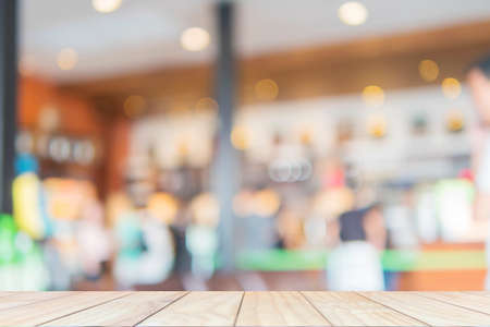 Wooden shelf over blurred coffee shop backgroundの写真素材