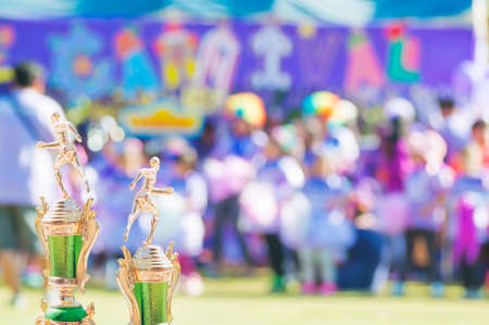 Sport trophy over blur crowded people in school sport day festivalの写真素材