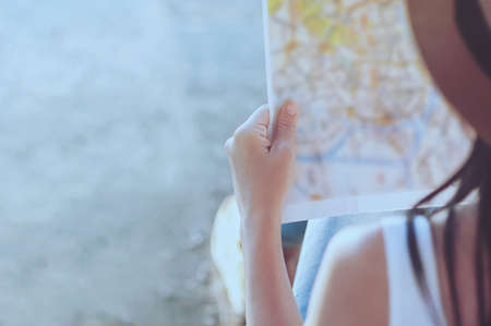 Tourist travel woman looking at the map while walking on a street  - street backpack travel conceptの写真素材