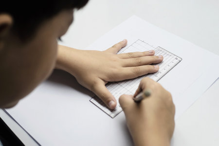 A boy is curiously doing homeworkの写真素材