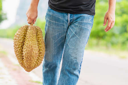 Man showing ripe durian happilyの写真素材