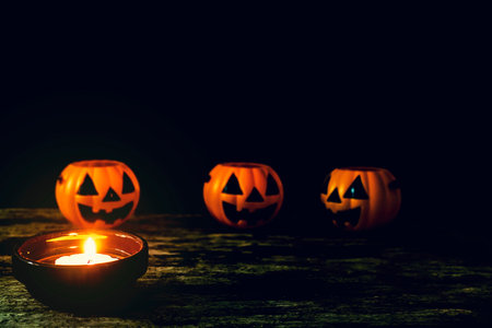 Candles and Halloween pumpkins are placed on wooden floors.の写真素材