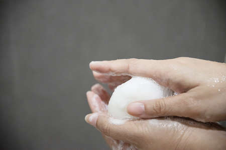 Lady hands with soap in a bath room - clean health care conceptの写真素材