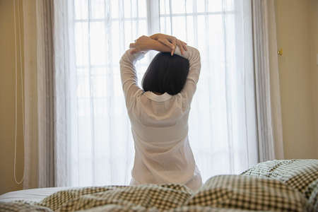 Lady wake up stretch oneself lazily for fresh morning - health care concept