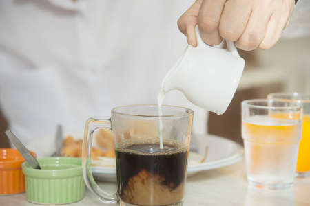 Business man eat the American breakfast set in a hotel - people take a breakfast in hotel concept