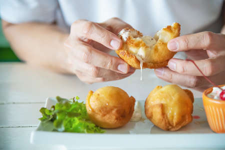 Man going to eat colourful fried ice cream ball dish - people with fast delicious unhealthy food...