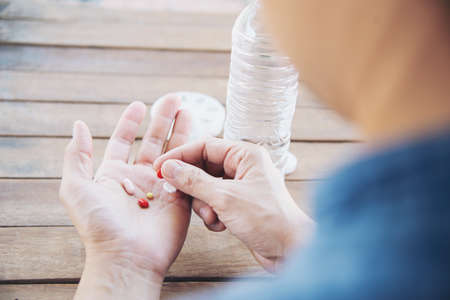 People prepare daily medicine tablet in pillbox - people healthcare with medicine pills concept