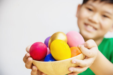 Child showing colorful Easter eggs happily - Easter holiday celebration conceptの写真素材