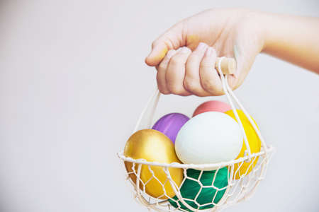 Child showing colorful Easter eggs happily - Easter holiday celebration concept