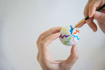 People painting colorful Easter eggs - Easter holiday celebration conceptの写真素材