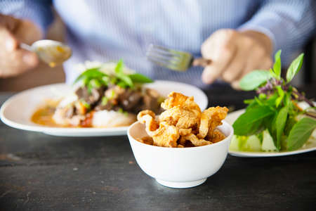 People eating spicy Northern Thai style noodle set - Thai food concept