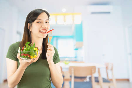 Happy lady holding kichen stuff over copy space background - people home made food preparation conceptの写真素材