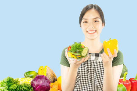 Happy lady holding kichen stuff over copy space background - people home made food preparation...