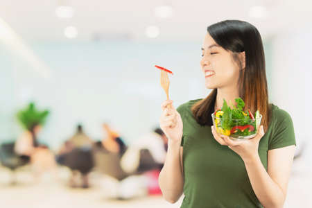 Happy lady holding kichen stuff over copy space background - people home made food preparation conceptの写真素材