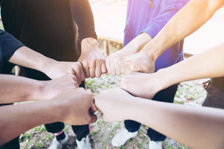 People join hand together during their work - human commitment conceptの写真素材