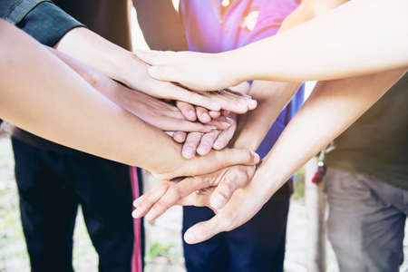 People join hand together during their work - human commitment conceptの写真素材