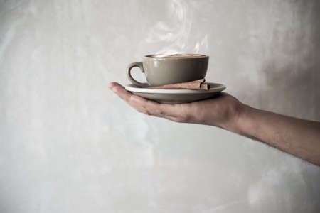 Hand holding hot coffee cup - people with coffee background conceptの写真素材