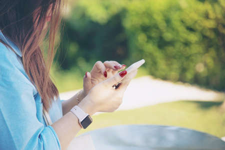 Woman using mobile phone - close up hand with mobile technology conceptの写真素材