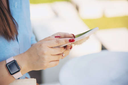 Woman using mobile phone - close up hand with mobile technology concept