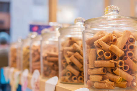 Tong Muan in glass container - a type of rolled wafer traditional Thai dessert