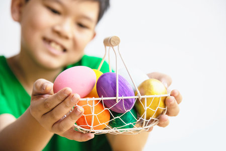 Child showing colorful Easter eggs happily - Easter holiday celebration concept