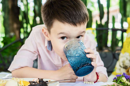 Portrait of happy Asian European boy drink water - relax child lifestyle concpet