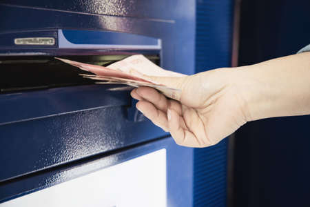 People waiting to get money from automated teller machine - people withdrawn money from ATM concept