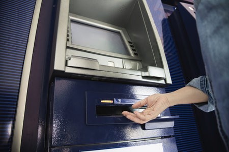 People waiting to get money from automated teller machine - people withdrawn money from ATM conceptの写真素材